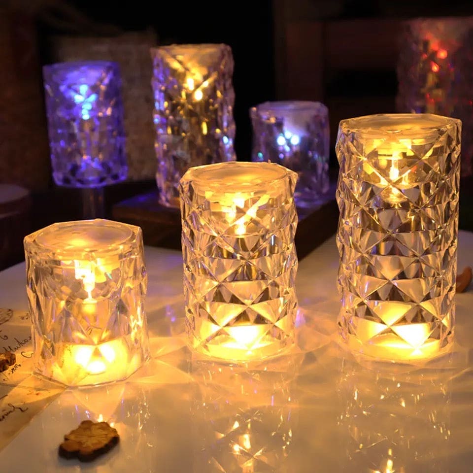 Crystal rose Crystal lamp set with warm glowing lights on a reflective surface