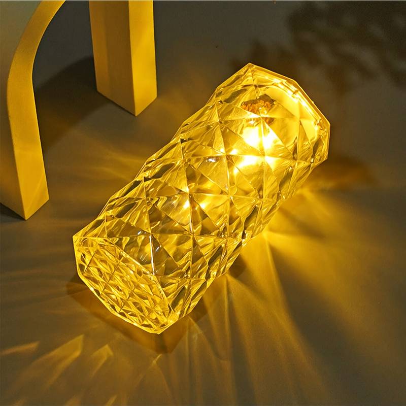 Elegant crystal rose Crystal lamp glowing warmly with intricate faceted design on surface