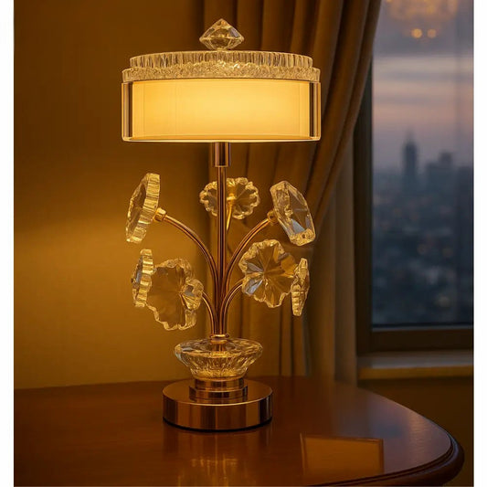 Elegant crystal table lamp gold stem with decorative crystal accents and warm beige lampshade on wooden table