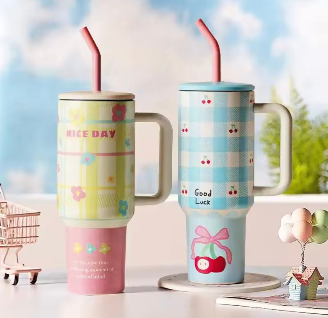 Two colorful 1200ml stainless steel tumblers with handles and straws featuring floral and cherry patterns