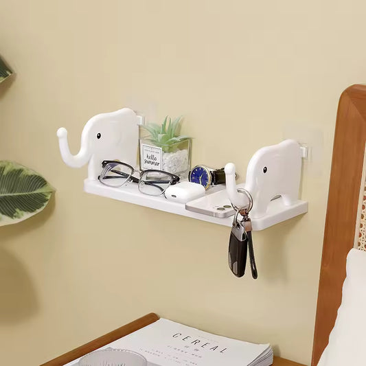 White cute animal design wall organizer shaped like elephants holding glasses, keys, and small items