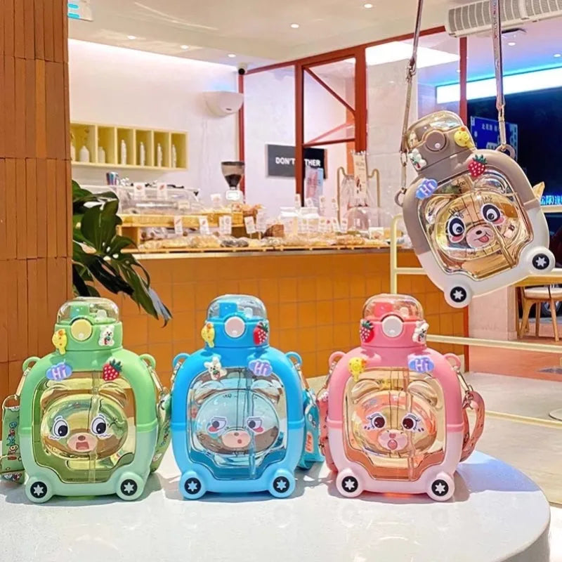 Colorful cute bear water cup for kids in green blue pink and brown displayed on table in cafe