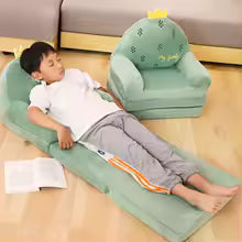 Cute cartoon children sofa in green with playful dinosaur design and reclined child resting