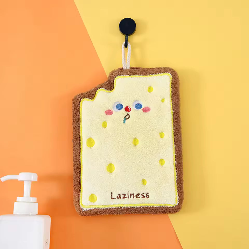 Cute coral velvet hand towels by Clarify.pk with adorable cartoon design and soft texture hanging on hook