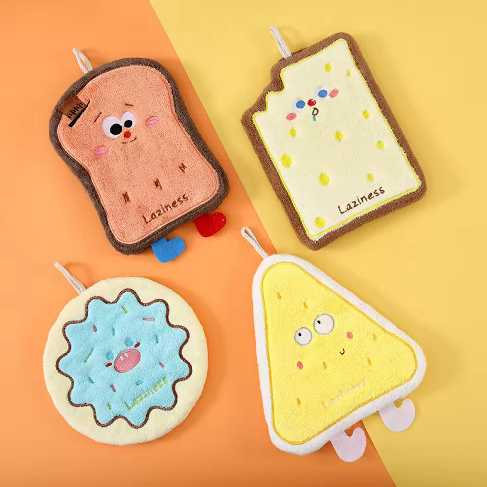 Cute coral velvet hand towels shaped like toast, cheese, and cookies with playful faces from Clarify.pk