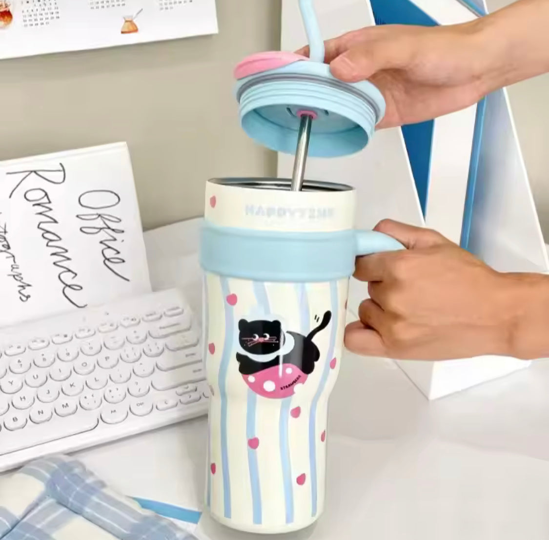 Cute stainless steel tumbler with straw featuring a black cat design and pastel blue lid