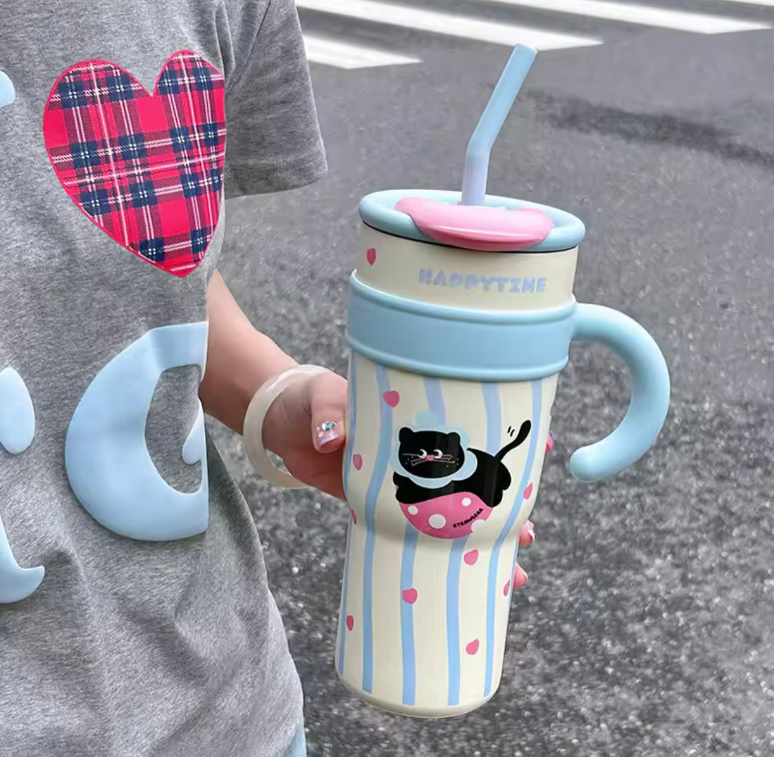 Cute stainless steel tumbler with straw featuring a black cat design and blue handle