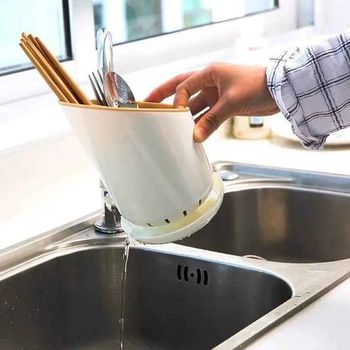 Handheld cutlery holder drying rack positioned over a sink for efficient utensil drying