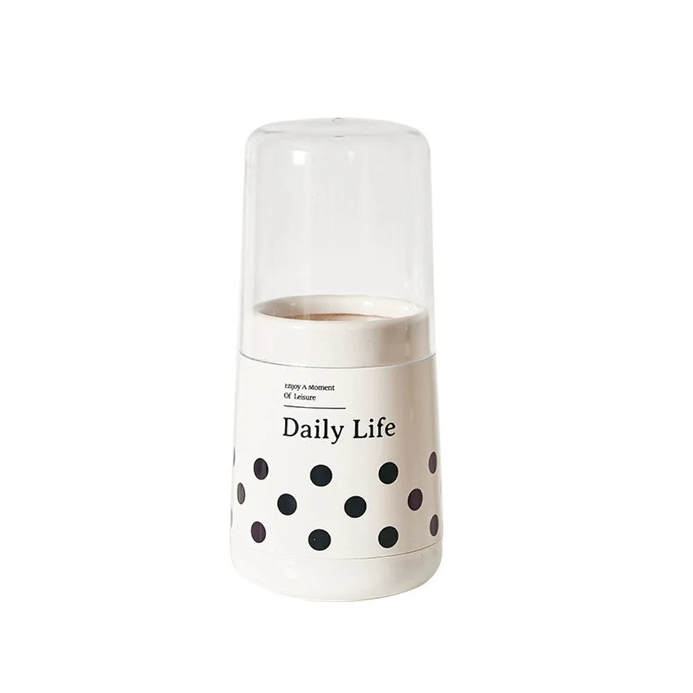 White kitchen utensil holder with lid featuring black polka dots and Daily Life text