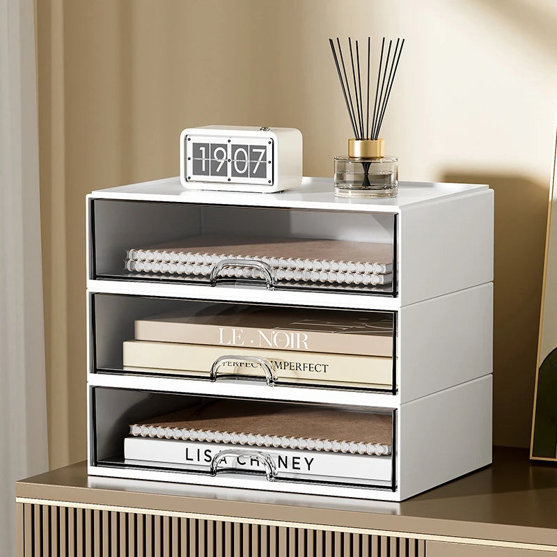 White desktop drawer storage box with three transparent drawers holding books and notebooks