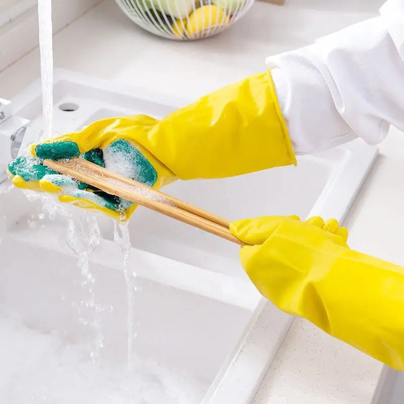 Clarify.pk yellow dishwashing gloves with sponge cleaning wooden chopsticks under running water