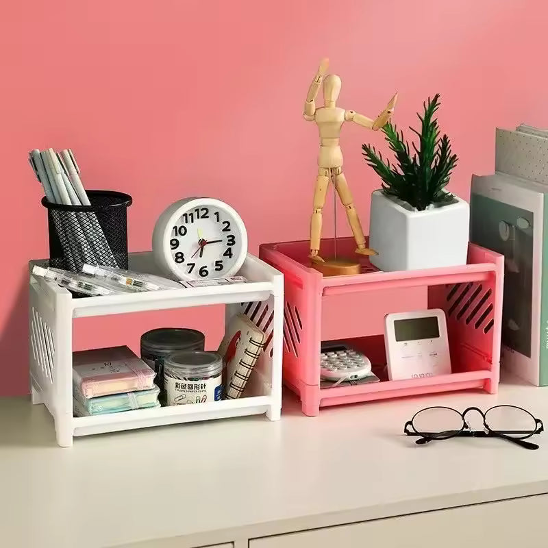 White and pink double layer desk organizer holding office supplies and decorative items on a white desk