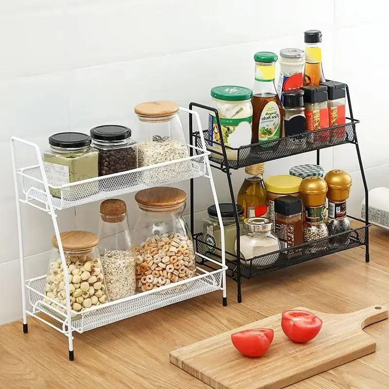 Double layer kitchen storage rack in white and black holding jars and spice bottles on wooden countertop