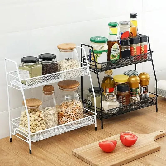 Double layer kitchen storage rack in white and black holding jars and spice bottles on wooden countertop