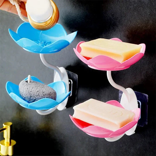 Double layer soap box shelf in blue and pink flower design mounted on black wall holding soap bars and scrub