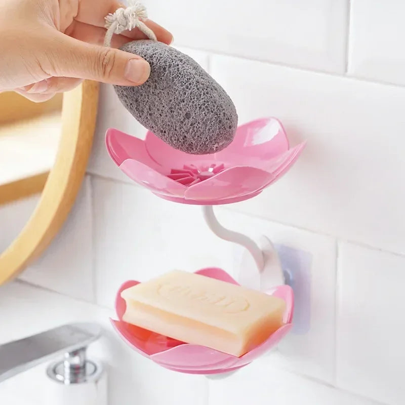 Pink double layer soap box shelf mounted on white tiled wall holding bar soap and pumice stone