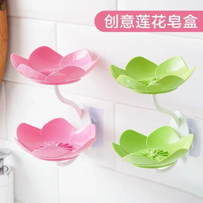 Pink and green flower-shaped double layer soap box shelf mounted on white tiled wall