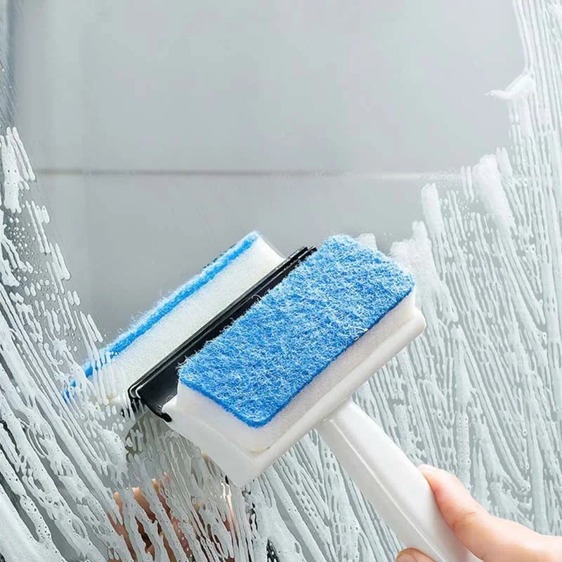 Clarify.pk double sided glass cleaning brush with blue scrub pads cleaning a glass surface