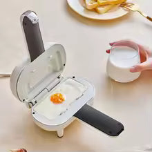 Clarify.pk double sided sandwich press cooking a fried egg on a white kitchen countertop