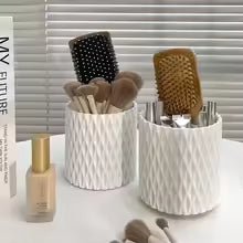 Makeup organizer storage box holding brushes and hair combs from Clarify.pk with a textured white design