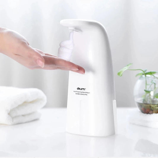 Clarify.pk white automatic foam soap dispenser dispensing foam onto a hand on a clean bathroom counter