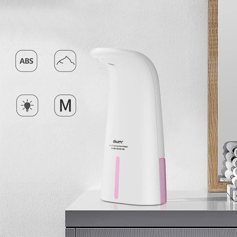 Clarify.pk portable automatic foam soap dispenser in white with pink accents on bathroom countertop