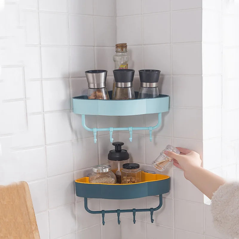 Wall-mounted corner shower shelf in blue and yellow holding spice jars in a tiled kitchen corner