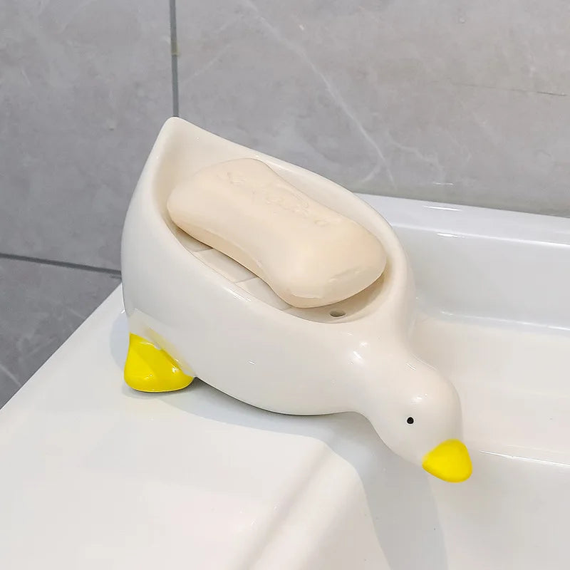Duck-shaped soap dish by Clarify.pk holding a white soap bar on bathroom sink