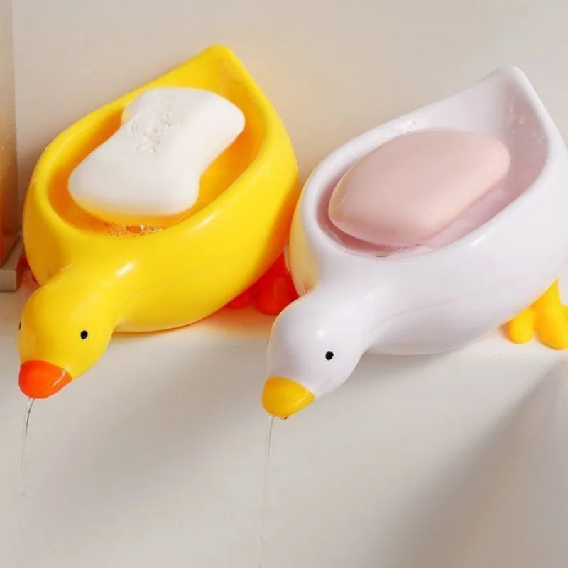 Clarify.pk yellow and white duck-shaped soap dish trays holding soap bars on a sink