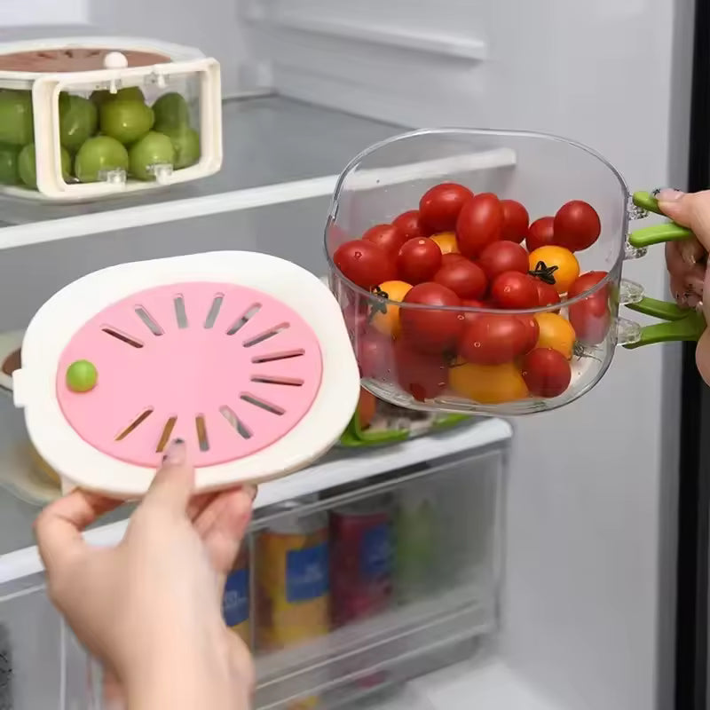 Dust-proof fruit drainer basket with transparent container and pink lid holding cherry tomatoes inside refrigerator