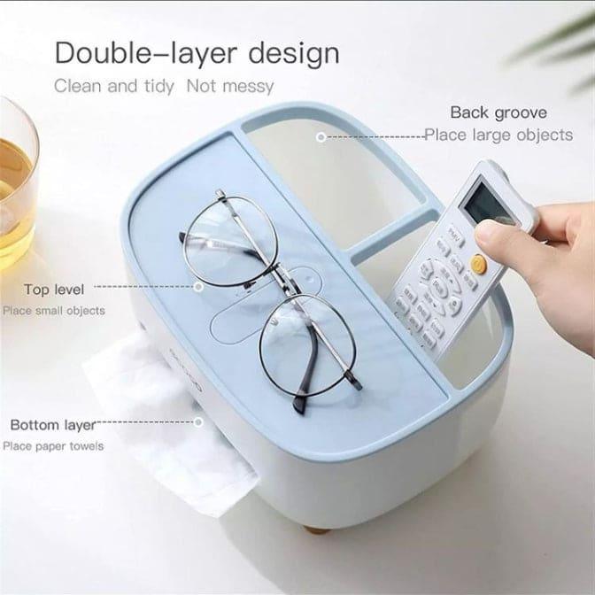 Ecoco tissue box holder with double-layer design in blue and white holding glasses and remote control