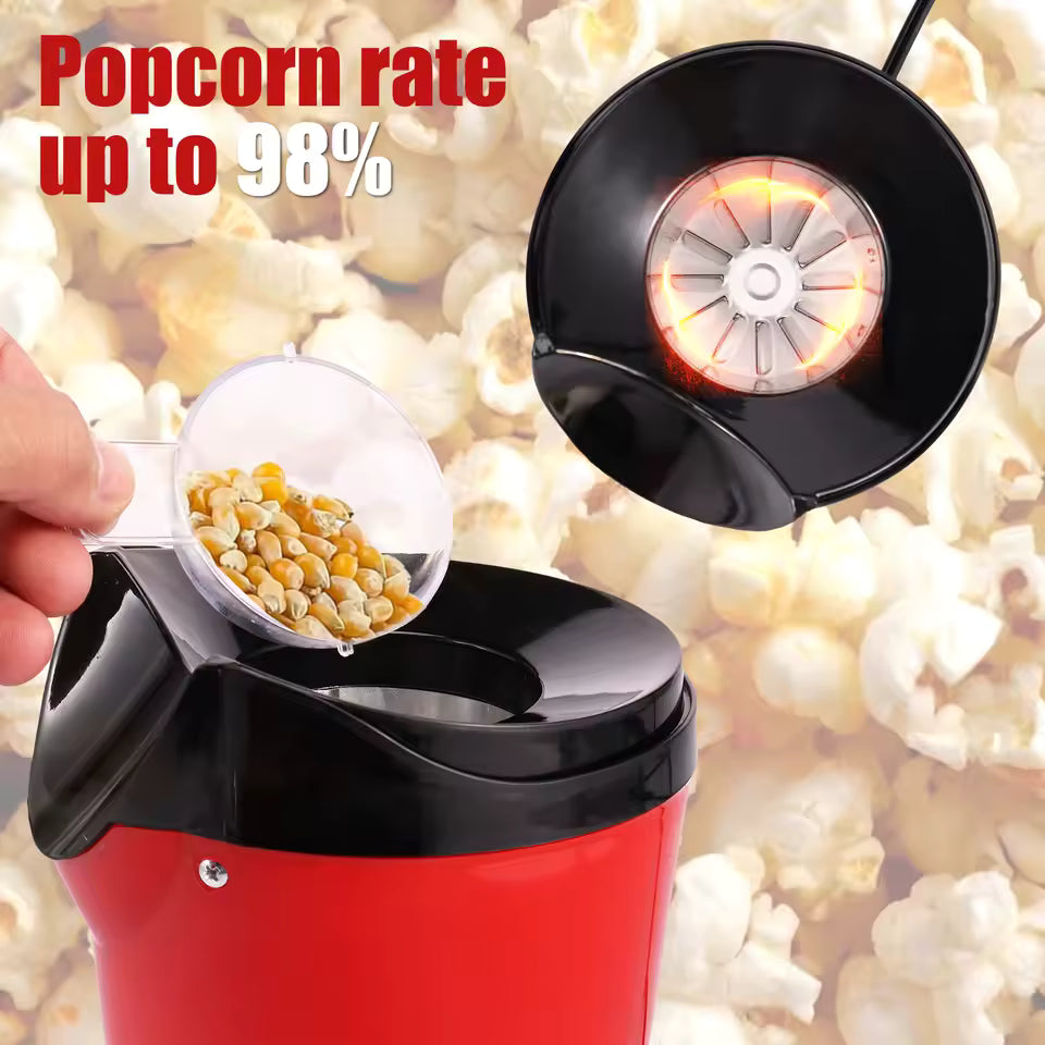 Red and black Willstar electric popcorn maker machine with a hand adding popcorn kernels