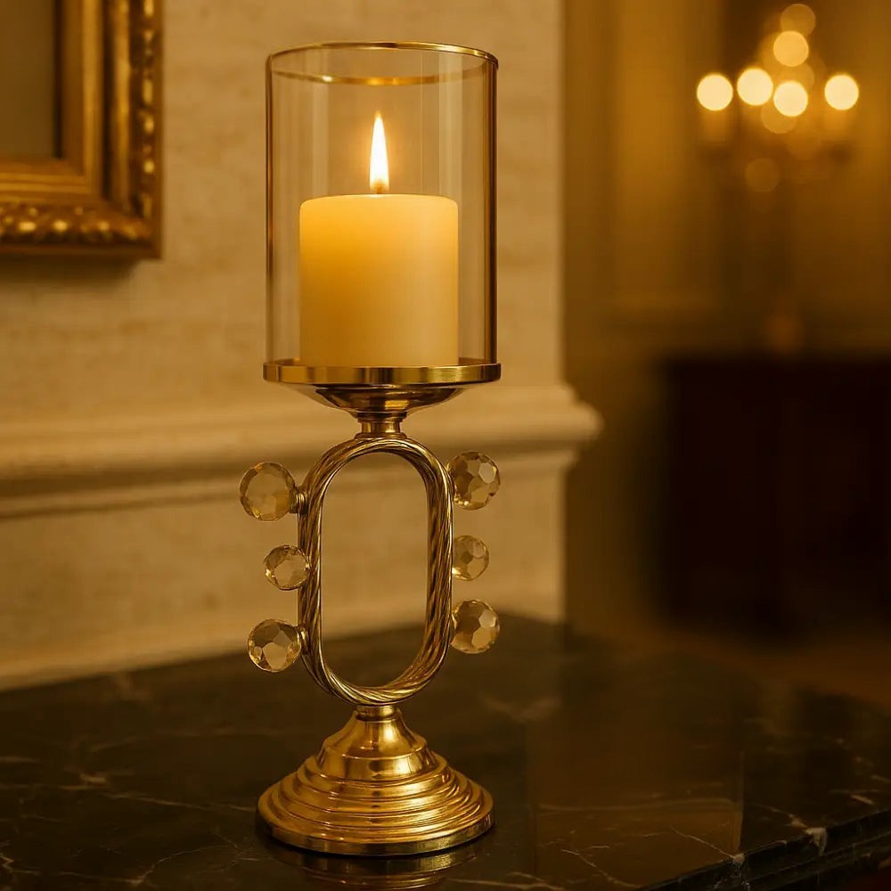 Elegant pillar candle holder with glass shade on a gold metal base with decorative crystals