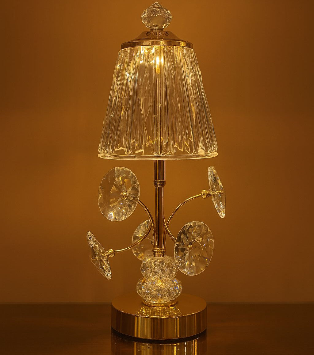 Elegant rechargeable bedside lamp with crystal decorations and a clear textured lampshade lit with warm light