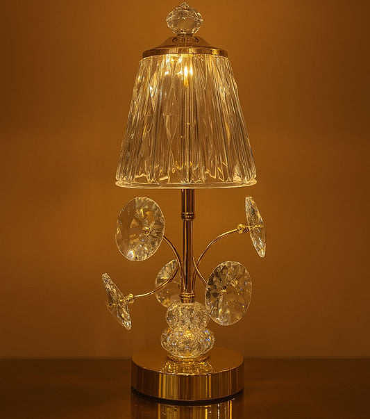 Elegant rechargeable bedside lamp with crystal decorations and a clear textured lampshade lit with warm light