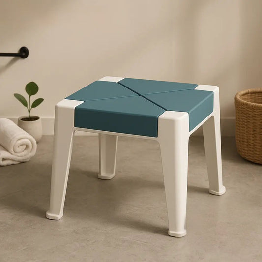 ErgoLuxe multipurpose stool for home in white with blue seat placed on bathroom floor near towel and plant