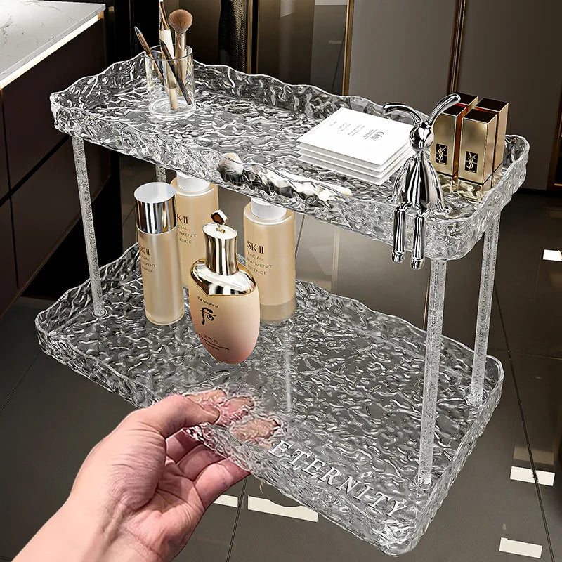 Clarify.pk clear bathroom organizer shelves with two textured tiers holding skincare and makeup items
