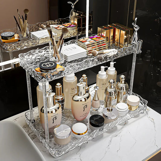 Clarify.pk clear acrylic bathroom organizer shelves holding skincare bottles and makeup items on a marble countertop