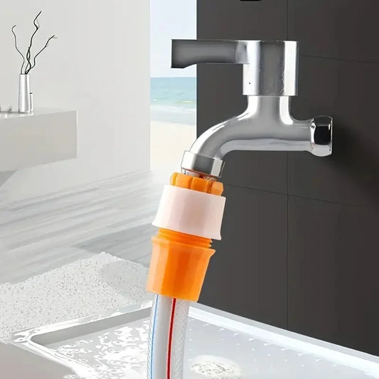 Silver faucet with orange and white plastic faucet connector hose attached to sink in modern bathroom