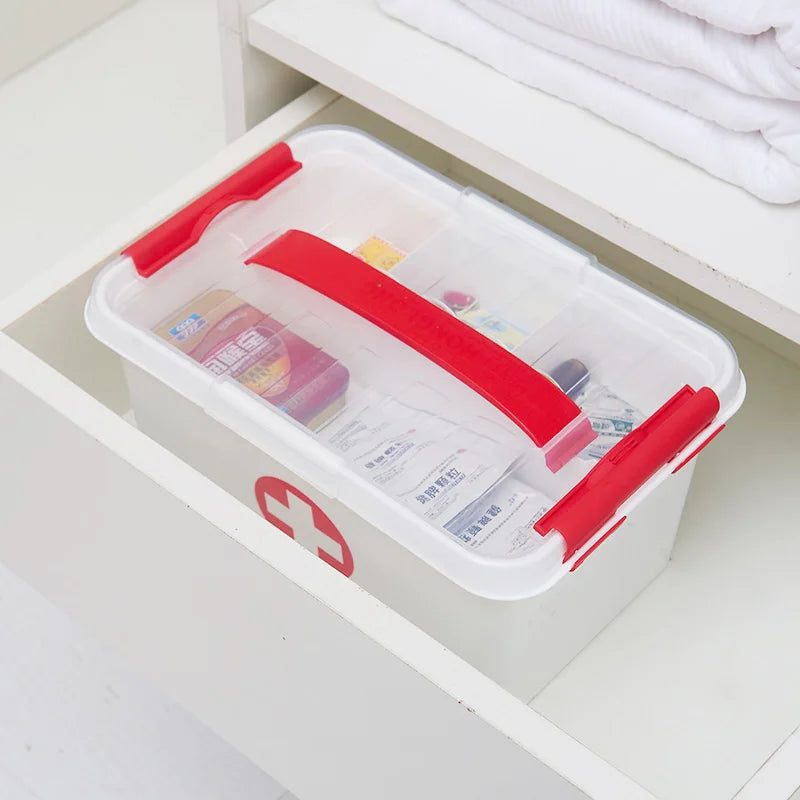Clarify.pk first aid kit storage box with red handle and secure latches organized in a white drawer