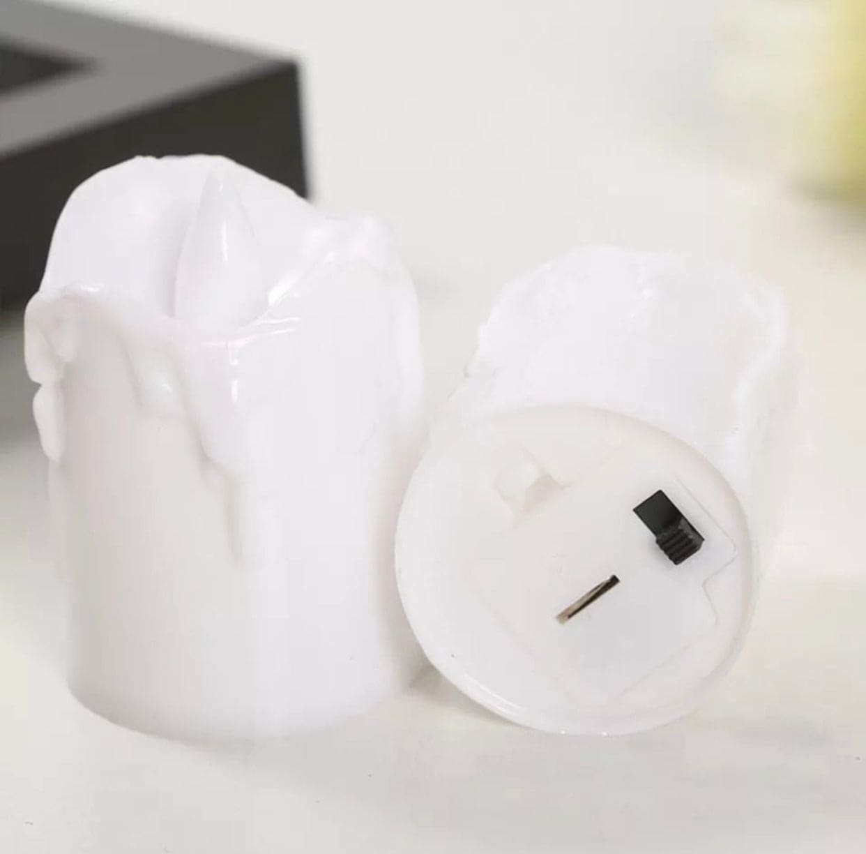 White flameless LED tea lights set with realistic melting wax design and battery compartment
