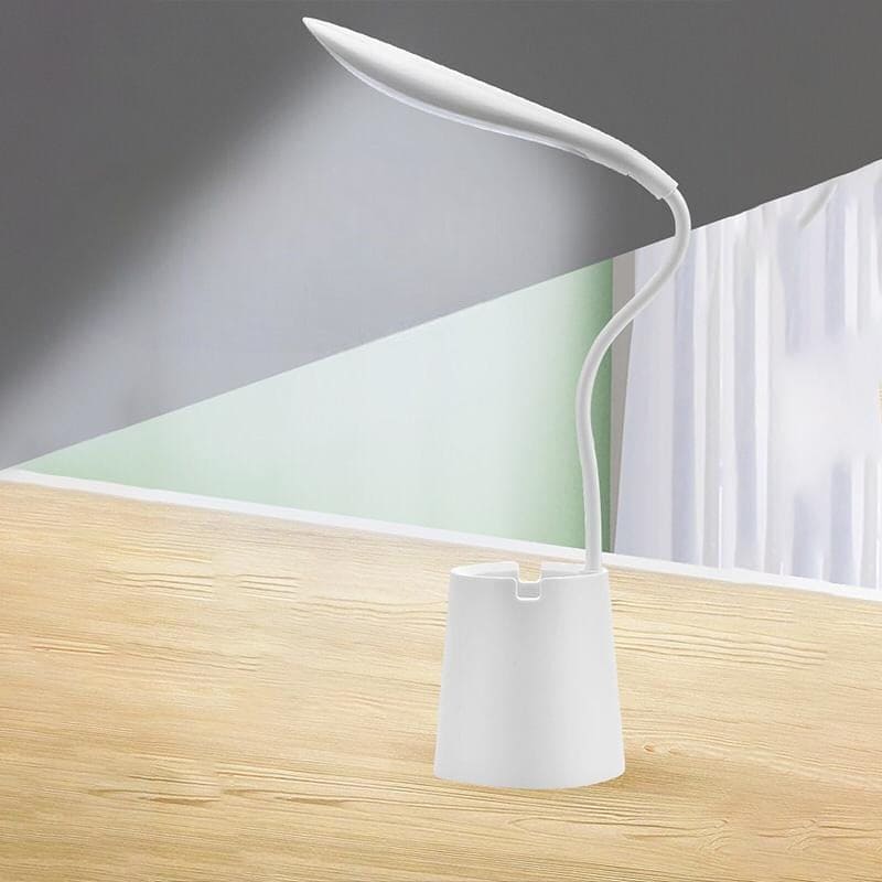 White flexible smart LED desk lamp with curved design illuminating wooden desk surface