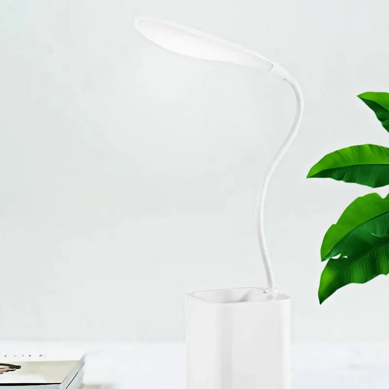 White flexible smart LED desk lamp with adjustable neck and modern design on white desk