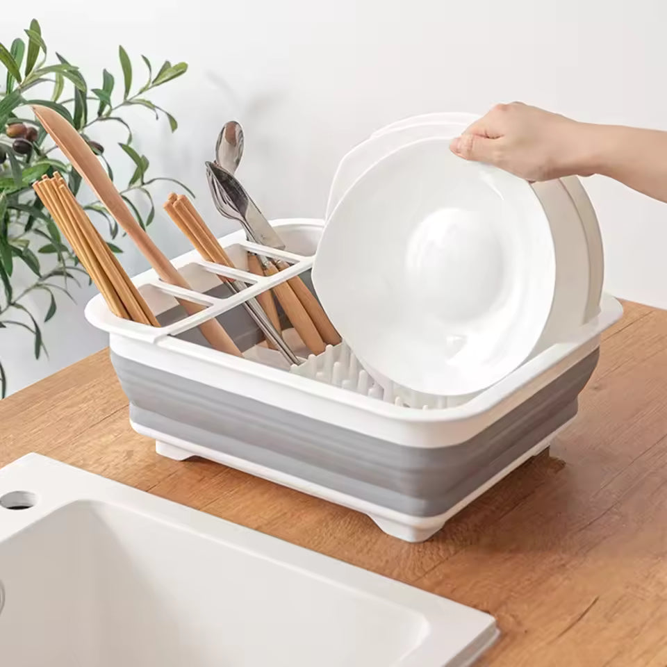 Foldable dish drainer rack by Clarify.pk holding plates, spoons, and chopsticks on a kitchen countertop