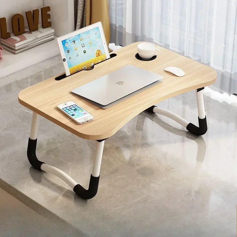 Clarify.pk foldable laptop desk in light wood finish with cup holder and device slots on marble surface