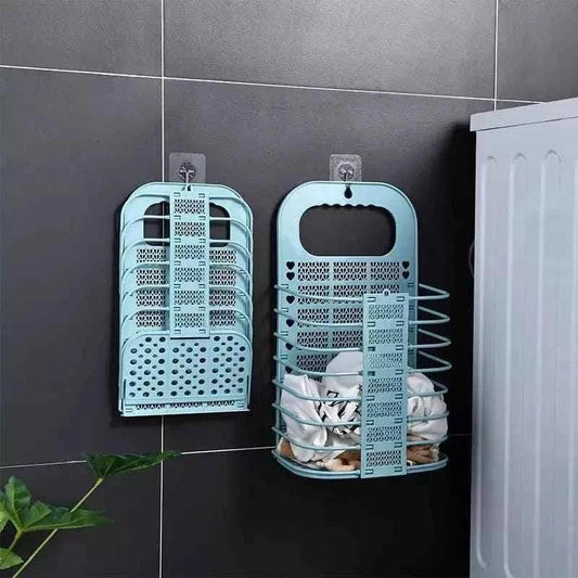 Clarify.pk foldable laundry basket in blue mounted on black wall next to washing machine