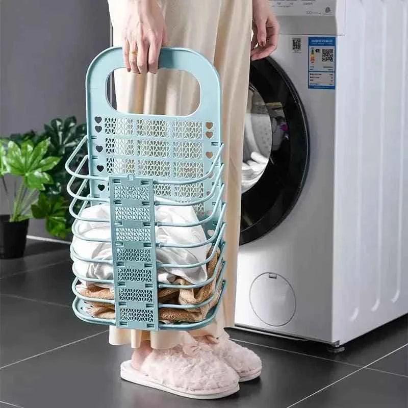 Light blue foldable laundry basket held by person wearing slippers next to a washing machine
