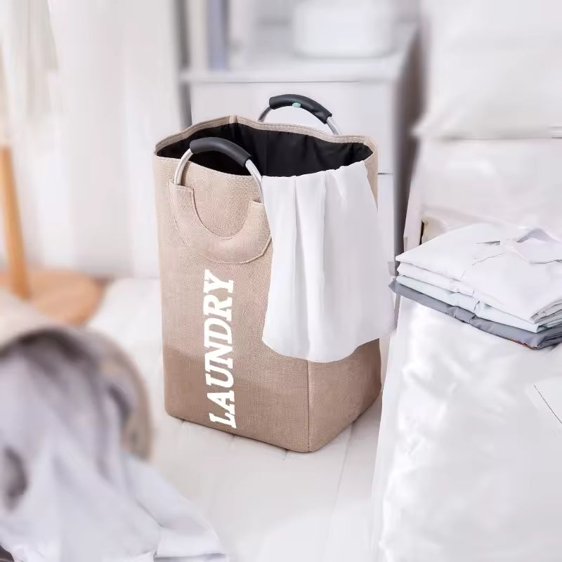 Clarify.pk foldable laundry hamper with handles in beige fabric with white laundry text and black interior