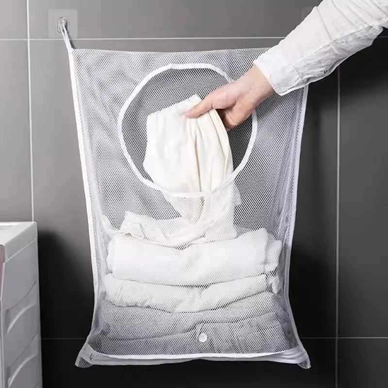 Foldable mesh clothes organizer hanging on bathroom wall with white laundry inside