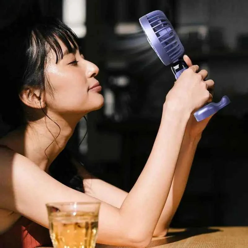 Clarify.pk foldable USB table fan in use, providing a refreshing breeze on a warm day